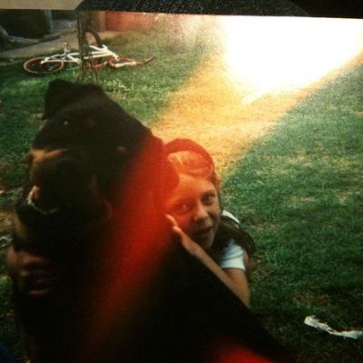 Sara Mitich's childhood photo with her first pet dog wearing tshirt